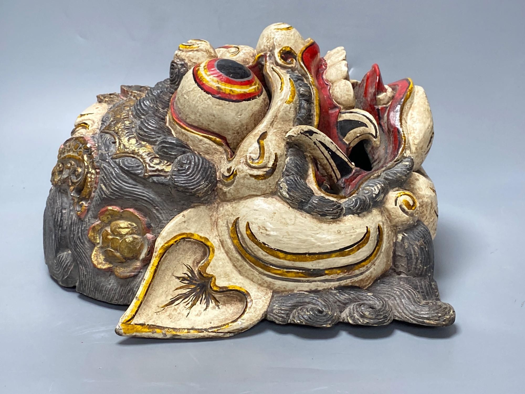 A Balinese carved and painted wood dragon mask, 28cm